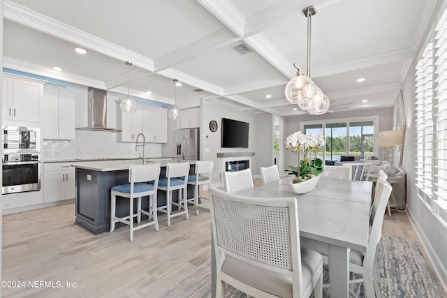 dining area featuring visible vents, coffered ceiling, light wood-style flooring, ornamental molding, and beamed ceiling