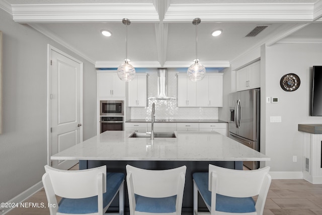 kitchen featuring stainless steel appliances, visible vents, a kitchen breakfast bar, wall chimney range hood, and backsplash