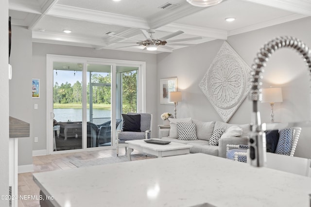 living room with visible vents, coffered ceiling, ornamental molding, a water view, and beam ceiling