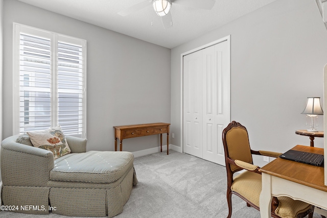 home office featuring carpet floors, baseboards, and a ceiling fan