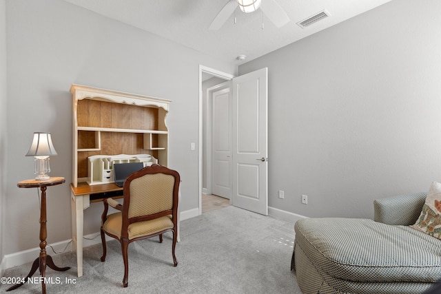 carpeted office featuring a ceiling fan, visible vents, and baseboards