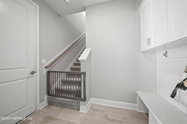 mudroom with light wood-type flooring and baseboards