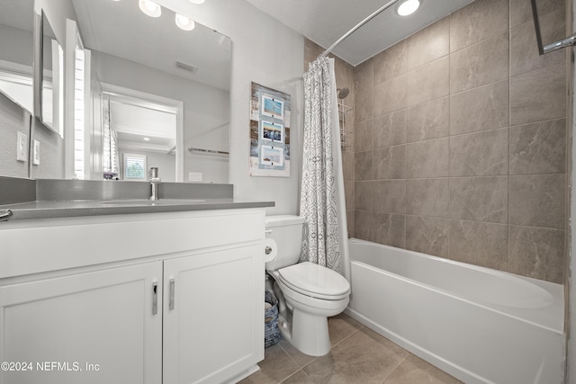 bathroom with toilet, shower / tub combo, vanity, visible vents, and tile patterned floors