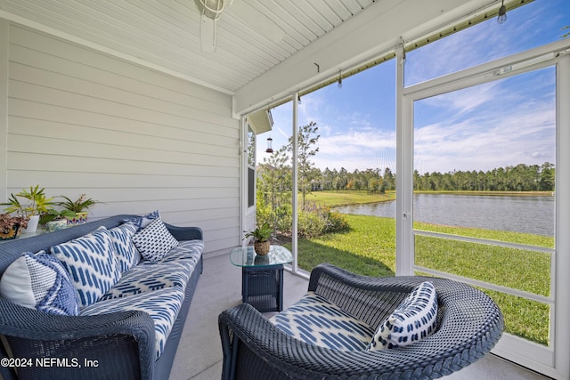 sunroom / solarium featuring a water view