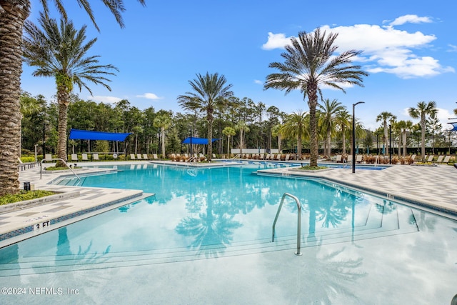 community pool with a patio area