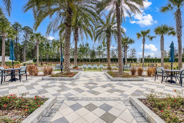 view of community with a patio and outdoor dining area