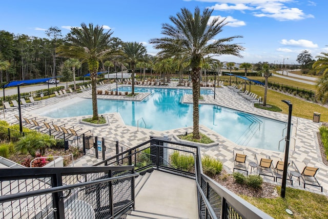 community pool featuring a patio area and fence