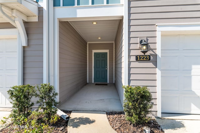 entrance to property featuring an attached garage