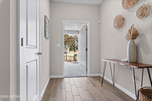 entryway featuring baseboards and wood finish floors