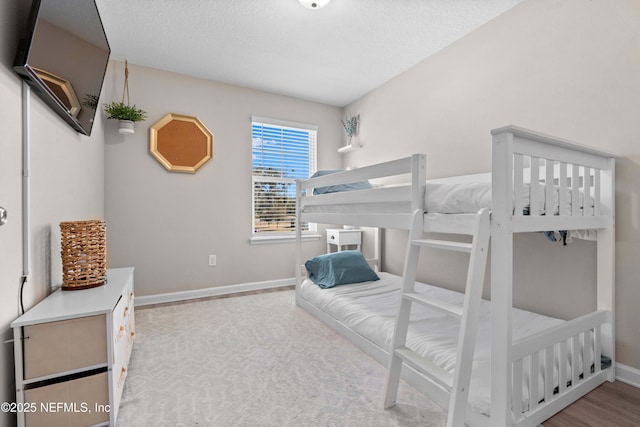 bedroom with baseboards and a textured ceiling