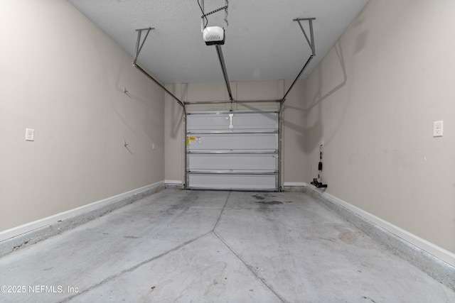 garage with a garage door opener and baseboards