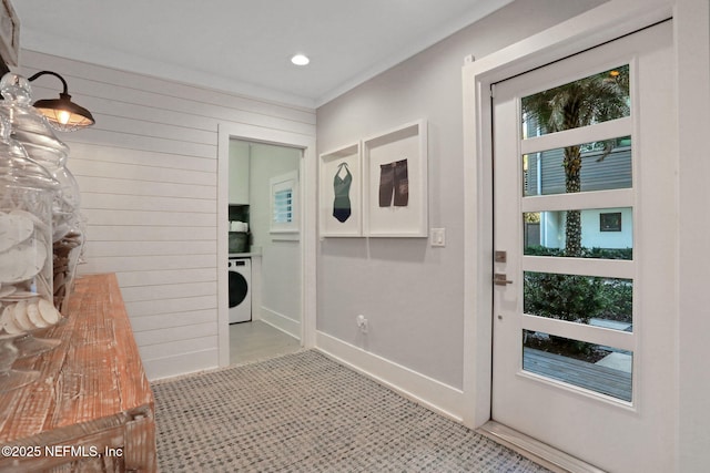 doorway to outside with recessed lighting, washer / clothes dryer, wooden walls, and baseboards