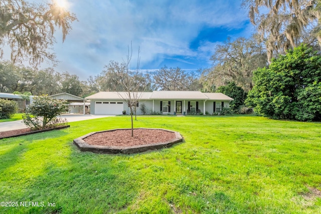 single story home featuring driveway, an attached garage, metal roof, and a front yard