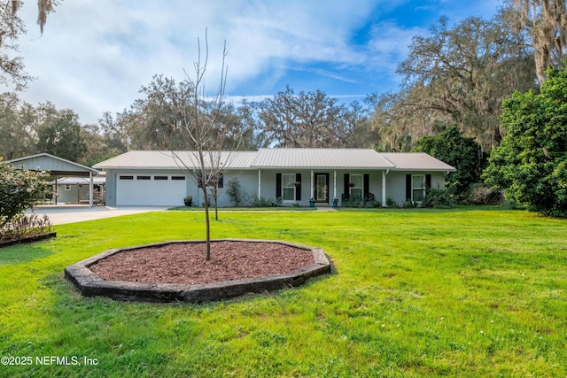 ranch-style home featuring metal roof, driveway, a front yard, and a garage