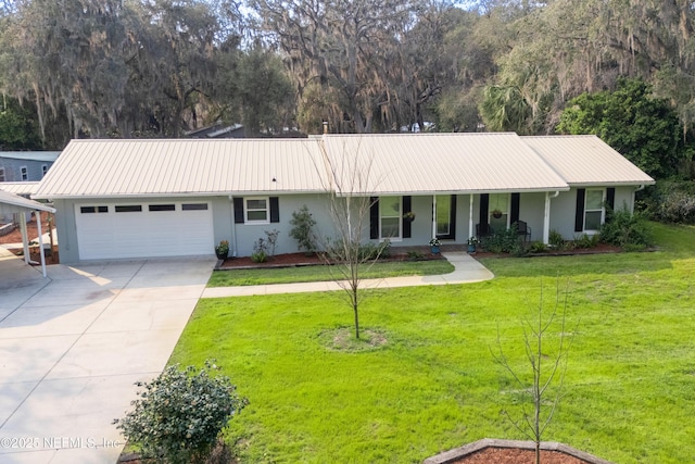 ranch-style house featuring stucco siding, concrete driveway, an attached garage, metal roof, and a front lawn