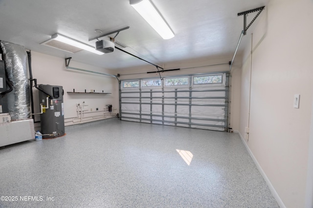 garage with baseboards, a garage door opener, and hybrid water heater