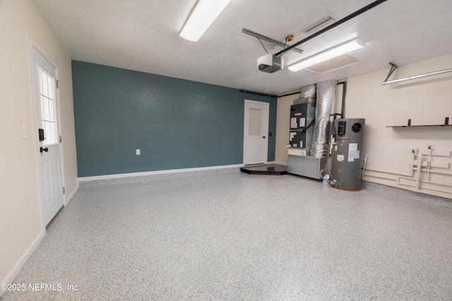 garage with a garage door opener, heating unit, hybrid water heater, and baseboards