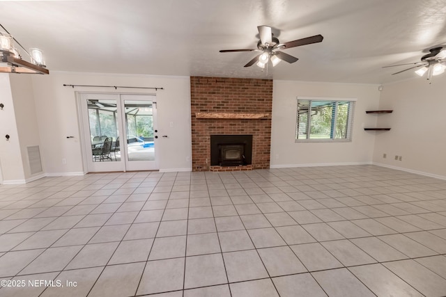 unfurnished living room featuring visible vents, plenty of natural light, baseboards, and ceiling fan