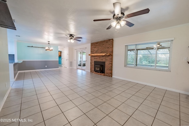 unfurnished living room featuring light tile patterned floors, a brick fireplace, baseboards, and a ceiling fan