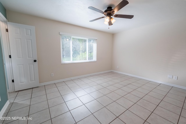 empty room with baseboards and a ceiling fan