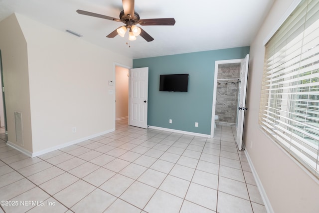 spare room with plenty of natural light, visible vents, and a ceiling fan