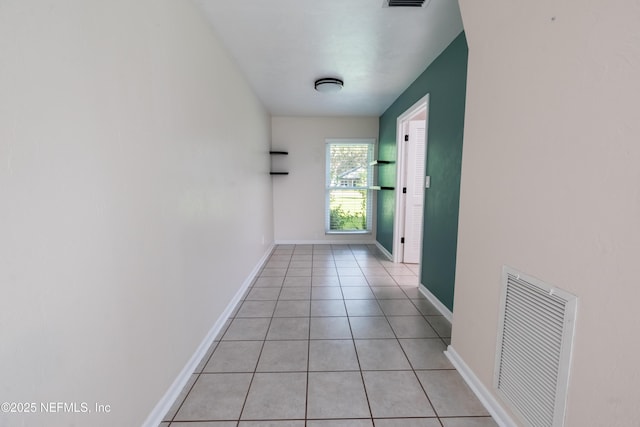 doorway to outside featuring light tile patterned floors, baseboards, and visible vents