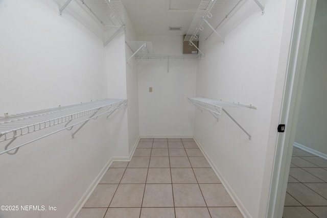 spacious closet with visible vents and light tile patterned flooring