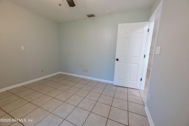 empty room with visible vents, ceiling fan, and baseboards