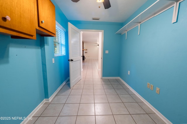 interior space with light tile patterned floors, ceiling fan, and visible vents