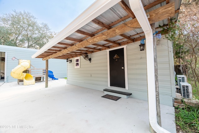 entrance to property featuring a patio