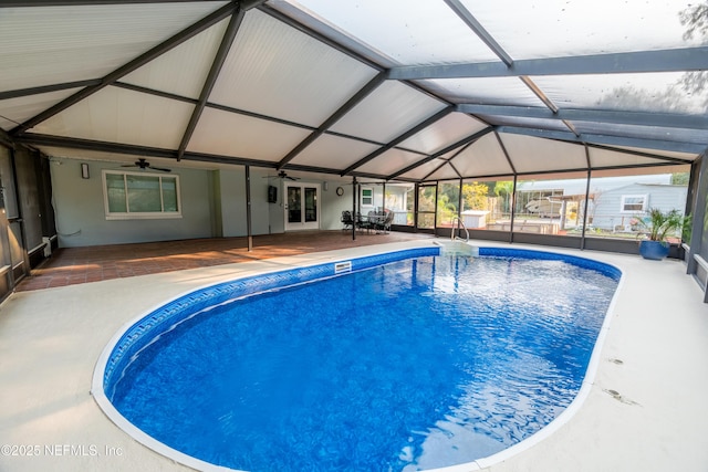 outdoor pool with ceiling fan, french doors, a patio area, and a lanai