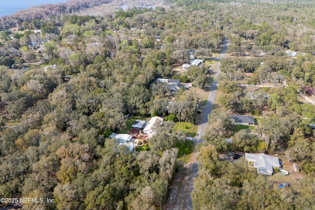 drone / aerial view featuring a wooded view