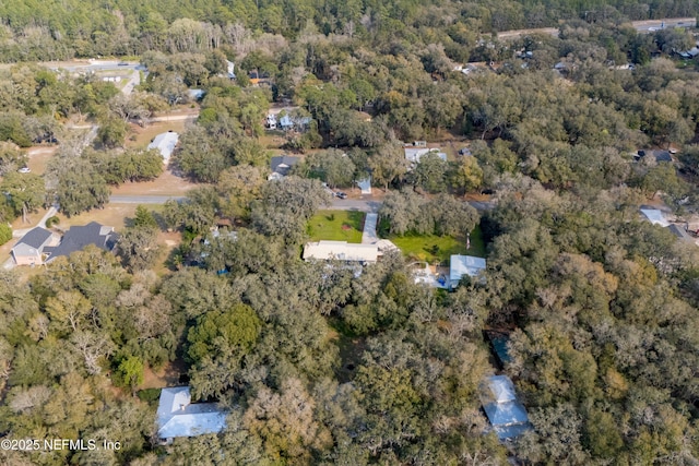 birds eye view of property with a forest view