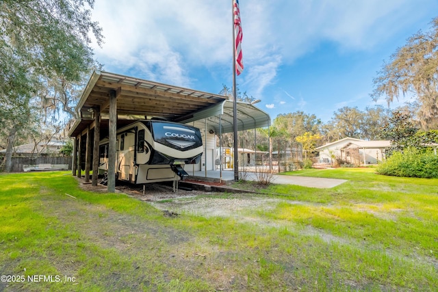 exterior space featuring a carport and fence