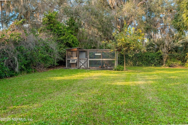 view of yard with an outdoor structure and exterior structure