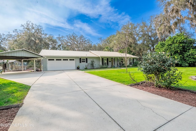 single story home with metal roof, an attached garage, concrete driveway, a carport, and a front lawn