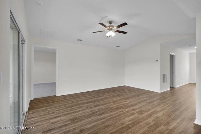 unfurnished room with lofted ceiling, visible vents, dark wood finished floors, and ceiling fan