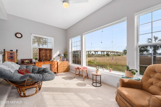 living area with baseboards, vaulted ceiling, and carpet flooring