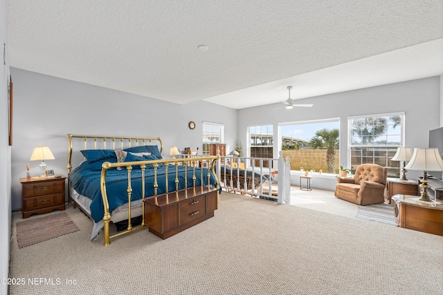 bedroom featuring a textured ceiling, a ceiling fan, and carpet flooring