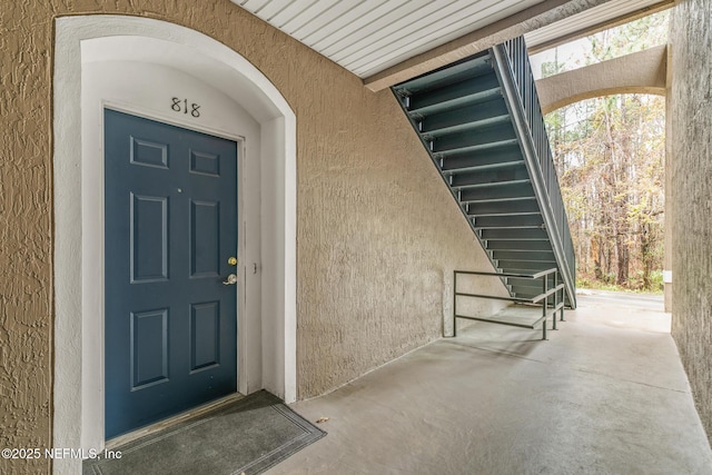 property entrance with stucco siding