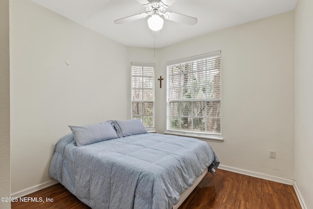 bedroom with wood finished floors, a ceiling fan, and baseboards