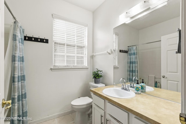 bathroom featuring toilet, a shower with shower curtain, tile patterned flooring, and vanity