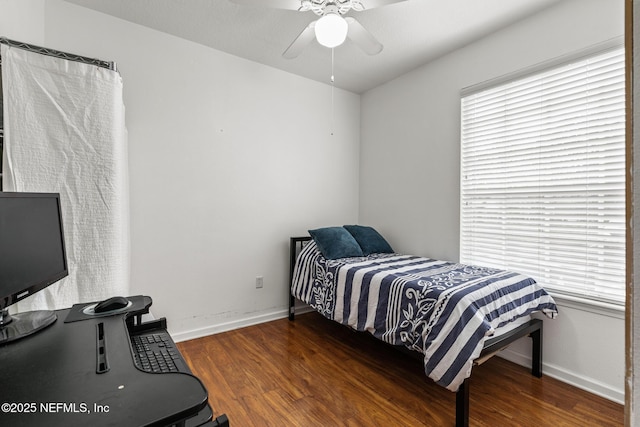 bedroom featuring ceiling fan, baseboards, and wood finished floors