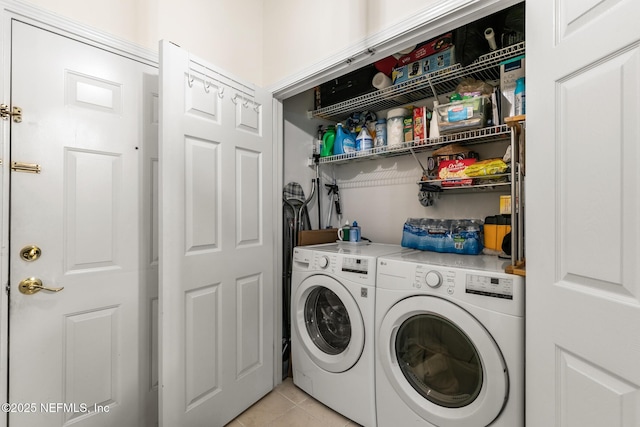 washroom featuring washer and dryer, laundry area, and light tile patterned floors