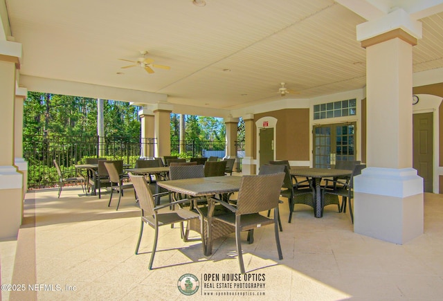 view of patio / terrace with fence, outdoor dining area, and a ceiling fan