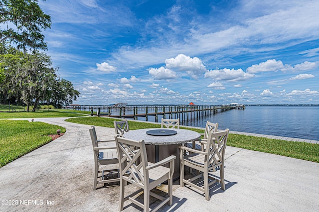 view of patio with outdoor dining space and a water view