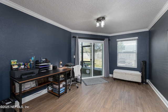 office space featuring crown molding, a textured ceiling, baseboards, and wood finished floors