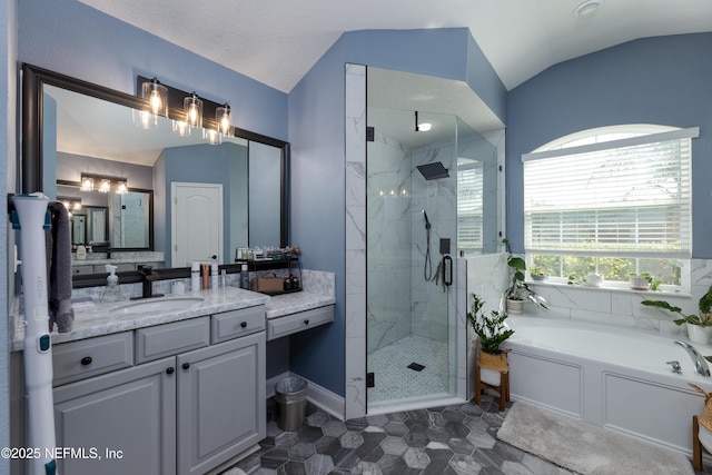 bathroom featuring lofted ceiling, a stall shower, a garden tub, and vanity