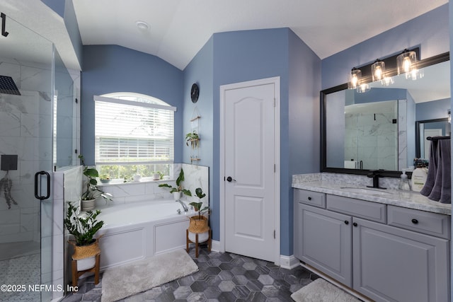 bathroom with lofted ceiling, vanity, baseboards, a shower stall, and a bath