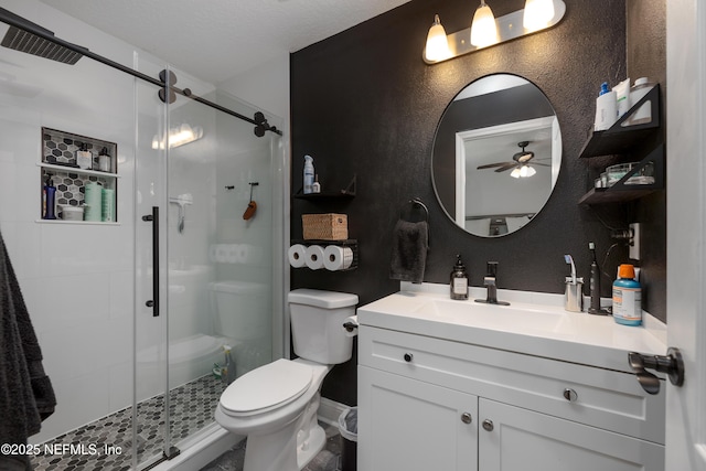 bathroom with toilet, a textured wall, a shower stall, and vanity